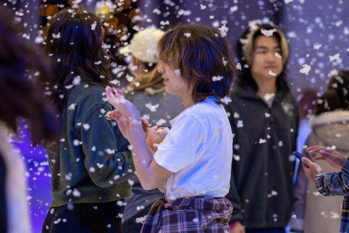 a group of people standing in the snow