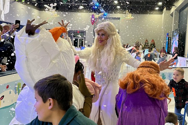 a group of people standing next to a kite