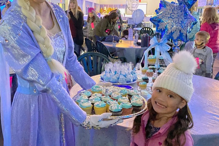 a woman standing in front of a cake